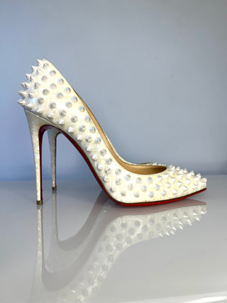 Christian Louboutin Pigalle Follies Spike  high-heeled pump in off-white leather covered with studs, featuring a pointed toe, slim stiletto heel, and the signature red sole
