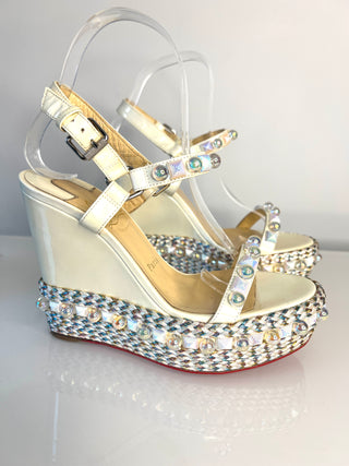 White wedge sandal with crystal embellishments on a white background