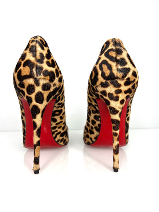 Leopard print high heels with red soles on a white background