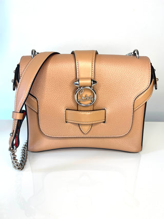 Christian Louboutin Rubylou tan pebbled leather shoulder bag with silver-tone hardware, featuring a front flap with a central Louboutin ring clasp and a strap.