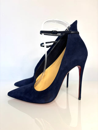 Navy blue high-heeled shoes with a clear plastic stand on a white background