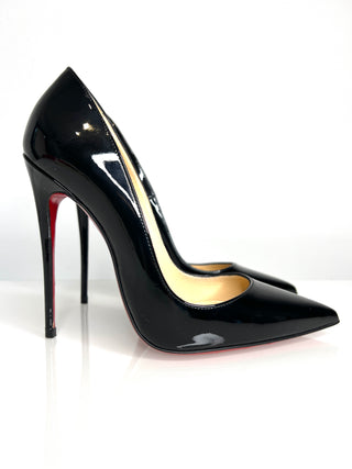 Black high-heeled shoe with a red sole on a white background