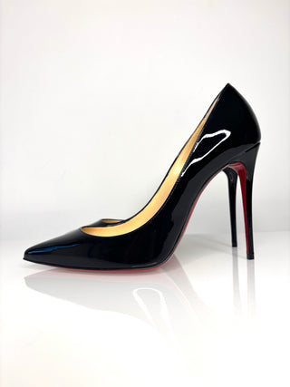 Black high-heeled shoe with red sole on a white background