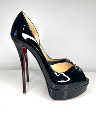 Black high-heeled shoe with a red sole on a white background