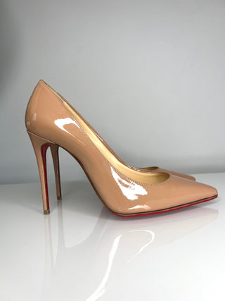 Christian Louboutin Kate nude patent leather high-heeled pump with a pointed toe and a signature red sole.
