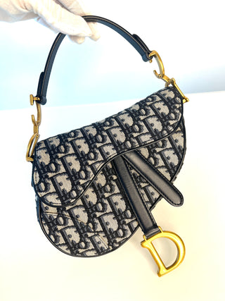 A Dior Saddle bag in navy and beige Oblique canvas with navy leather trim and gold-tone hardware