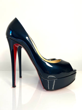 Black high-heeled shoe with red interior on a white background