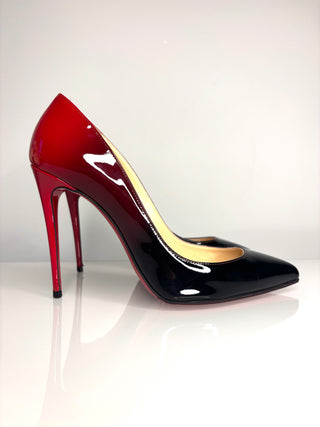 High-heeled shoe with red and black design on a white background