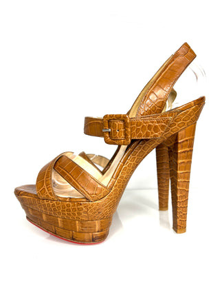 Brown high-heeled sandal with platform on a white background