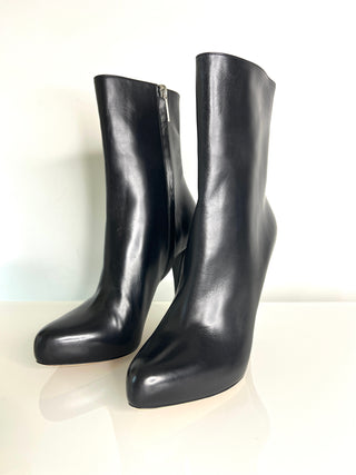 Pair of black leather knee-high boots on a white background