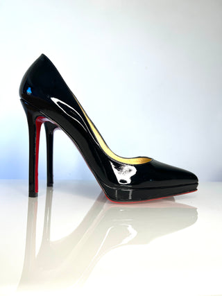 Christian Louboutin Pigalle Plato black patent leather high-heeled pump with a pointed toe, a slim stiletto heel, and a signature red sole