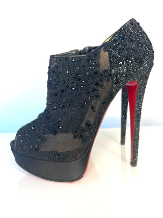 Black high-heeled booties with lace and crystal detail and red sole