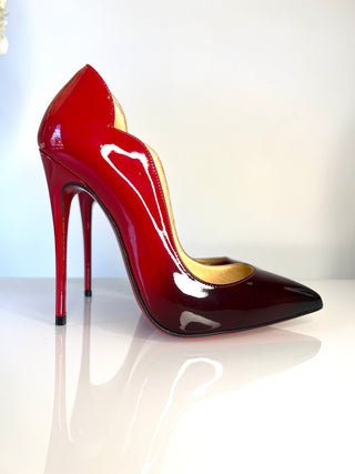Christian Louboutin Hot Chick high-gloss patent leather stiletto pump in a deep red gradient, featuring a pointed toe and a slim high heel