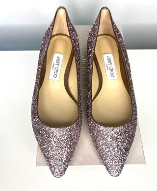 Pair of Jimmy Choo glittery high heels on a white background