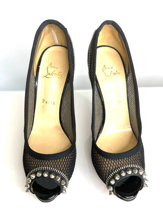 Black high-heeled shoes with studded details on a white background