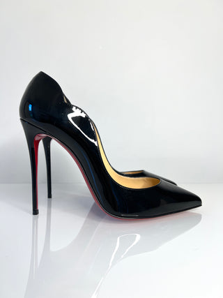 Black high-heeled shoe with red interior on a white background