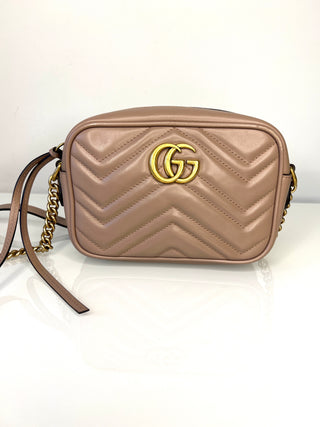 Beige handbag with gold accents on a white background