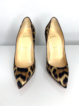 Pair of leopard print high heels on a white background