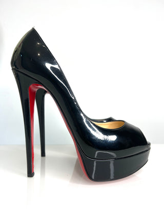 Black high-heeled shoe with red interior on a white background