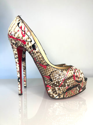 High-heeled peep-toe shoe with snake print and red accents on a white background