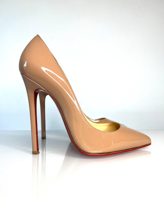 Christian Louboutin Pigalle nude patent leather high-heeled pump with a pointed toe and a signature red sole.