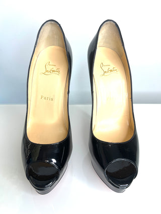 Black high-heeled shoes with open toes on a white background