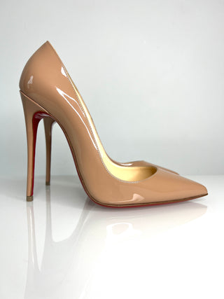 Beige high-heeled shoe with a red sole on a white background