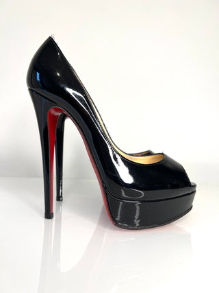 Black high-heeled shoe with red sole on a white background