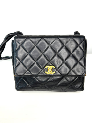 A Chanel vintage black quilted leather shoulder bag with a gold-tone interlocking CC logo on the front