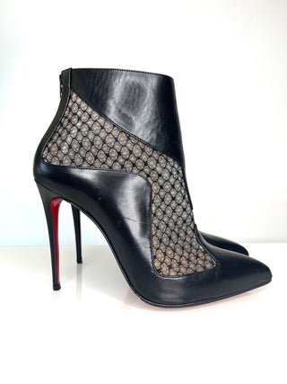 Black high-heeled shoe with patterned side on a white background