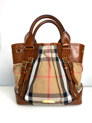 Designer handbag with checkered pattern and brown leather accents on a white background