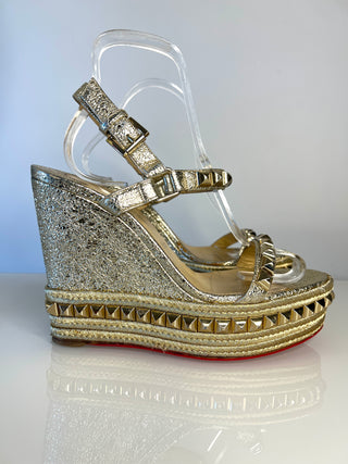 Christian Louboutin metallic gold wedge sandals with  a studded platform sole, and a red outsole