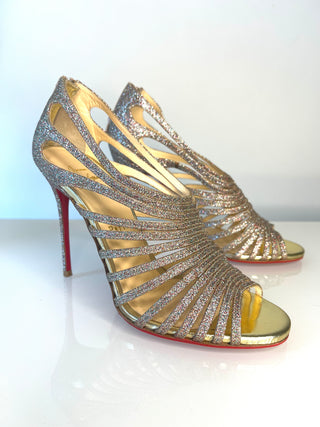 Christian Louboutin Multibrida gold glitter strappy high-heeled sandals with a signature red sole.