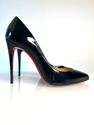 Christian Louboutin Pigalle Follies black patent leather stiletto pump with a pointed toe and a signature red sole 