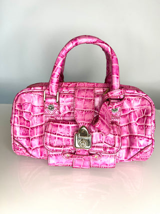Pink textured  bowler style handbag with a gold lock on a light gray background