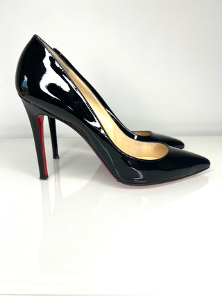 Black patent high-heeled shoes on a white background