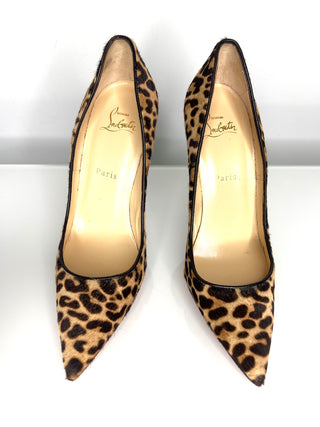 Pair of leopard print high heels with visible brand name on a white background