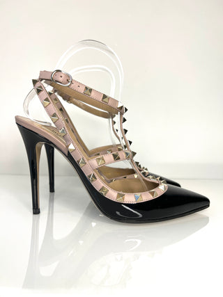 Black high-heeled sandal with studded design on a white background
