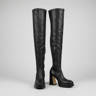 A pair of Souliers Martinez black leather over-the-knee boots with chunky block heels and platform soles.