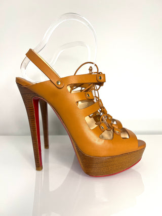 Tan high-heeled sandal with wooden sole on a white background