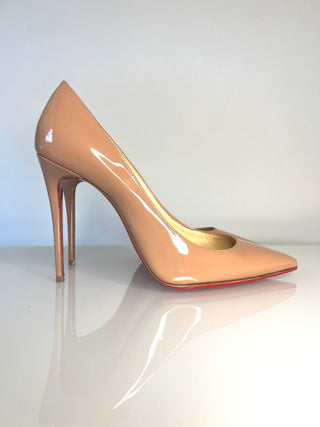 Christian Louboutin Kate nude patent leather stiletto pump with a pointed toe and a signature red sole.