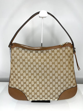 Beige handbag with brown accents on a white background