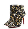 black leather ankle booties with silver and gold studded design and signature red soles