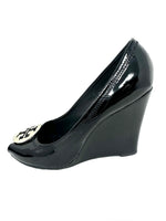 Black patent leather wedges with silver signature logo on the uppers and peep toe finish